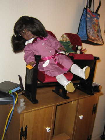 May leans over the edge of her theater seat, trying to lure Sammy with a Cheez-It.