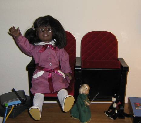 May waves while Nellie uses her cat toy Mabel as a swordfighting target.