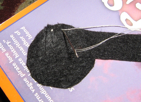 Sewing the band to the top of the hat