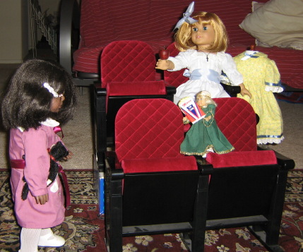 May comes to the theater scene. Nellie holds out an artificial apple.